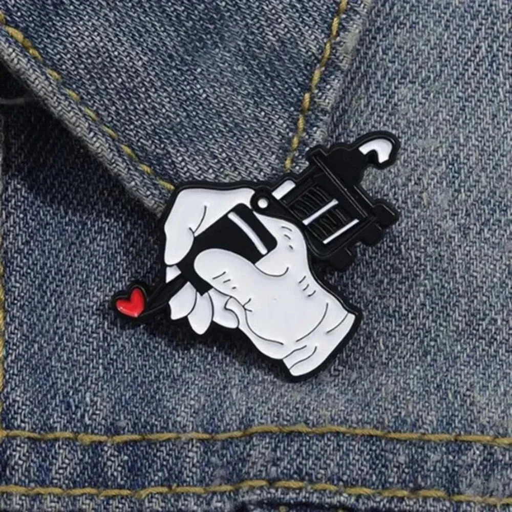 1 piece unisex black white with red heart hand holding tattoo gun enamel pin